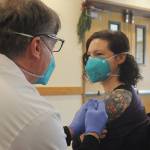 Robin Worth-McIntyre, a nurse technician at Avamere Olympic Rehabilitation of Sequim, gets a Pfizer vaccine shot from Walgreens pharmacist Steve Sommers.  (Michael Dashiell/Olympic Peninsula News Group)