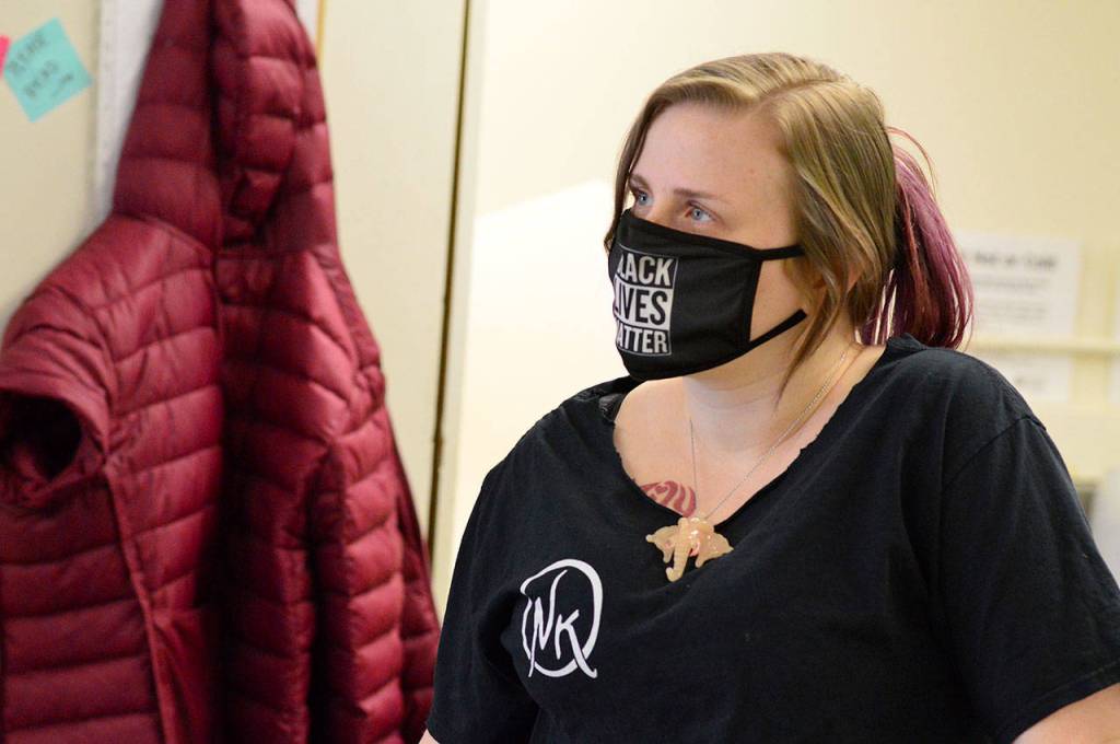 Terra Hampton, a member of the Nadines Kitchen crew, works with Grace Love, cooking hundreds of meals for the YMCA-Community Wellness Project program for local families. (Diane Urbani de la Paz/Peninsula Daily News)