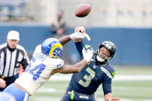 Los Angeles Rams outside linebacker Leonard Floyd (54) knocks the ball away as Seattle Seahawks quarterback Russell Wilson tries to pass during the first half of an NFL wild-card playoff football game, Saturday, Jan. 9, 2021, in Seattle. (AP Photo/Scott Eklund)