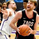 Gonzaga forward Drew Timme, right, drives to the basket on Portland forward Mikey Henn, left, during the first half of an NCAA college basketball game in Portland, Ore., Saturday, Jan. 9, 2021. (AP Photo/Steve Dykes)