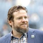 Seattle Seahawks general manager John Schneider walks on the field during warmups before a game against the Los Angeles Rams in October 2019 in Seattle. The Seahawks have agreed to a contract extension with Schneider that will keep him tied to the franchise through the 2027 draft. (Elaine Thompson/The Associated Press)