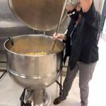 Bobi Beery, part of the gleaning team in Jefferson County, works with a fraction of the apple yield from last fall. She and fellow volunteers turned ugly apples into sauce for Port Townsend school meals. (Photo courtesy of Mary Hunt)