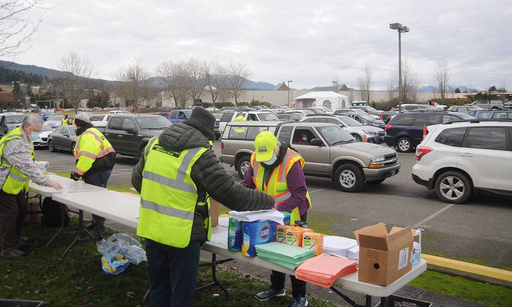 Members of the Community Emergency Response Team organize material at the registration checkpoint of the Jamestown SKlallam Tribes COVID-19 vaccination clinic on Jan. 14. Sequim Gazette photo by Michael Dashiell