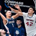 Gonzaga guard Jalen Suggs (1) shoots against Saint Mary's forward Dan Fotu (42) during the second half of an NCAA college basketball game in Moraga, Calif., Saturday, Jan. 16, 2021. (AP Photo/Jeff Chiu)