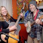 Kim Trenerry and Jason Mogi, who perform as Deadwood Revival, practice in their Port Angeles home on Thursday in preparation for a live-streamed concert for the Juan de Fuca Foundation's Winter Benefit on Saturday night. (Keith Thorpe/Peninsula Daily News)