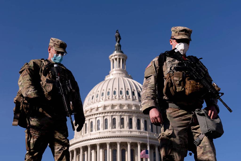 Members of the National Guard walk past the Dome of the Capitol Building on Capitol Hill in Washington on Thursday, Jan. 14, 2021. (Andrew Harnik/The Associated Press)