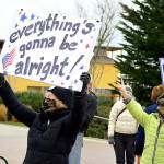 As motorists honked, Linda Abbott-Roe held up her message during the Inauguration Day celebration in downtown Port Townsend. (Diane Urbani de la Paz/Peninsula Daily News)