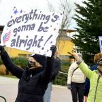As motorists honked, Linda Abbott-Roe held up her message during the Inauguration Day celebration in downtown Port Townsend. (Diane Urbani de la Paz/Peninsula Daily News)