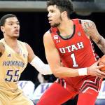 Utah forward Timmy Allen (1) tries to get around Washington guard Quade Green (55) during the first half of an NCAA college basketball game, Sunday, Jan. 24, 2021, in Seattle. (AP Photo/Ted S. Warren)