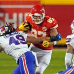 Kansas City Chiefs tight end Travis Kelce (87) runs from Buffalo Bills linebacker Tremaine Edmunds (49) and safety Jordan Poyer (21) after catching a pass during the first half of the AFC championship NFL football game, Sunday, Jan. 24, 2021, in Kansas City, Mo. (AP Photo/Charlie Riedel)