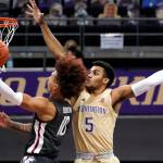 Washington's Jamal Bey (5) defends as Washington State's Isaac Bonton shoots in the first half of an NCAA college basketball game Sunday, Jan. 31, 2021, in Seattle. (AP Photo/Elaine Thompson)