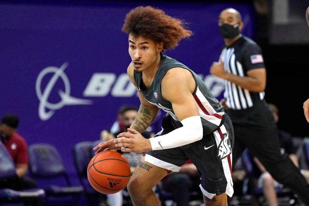 Washington State's Isaac Bonton drives against Washington in the first half of an NCAA college basketball game Sunday, Jan. 31, 2021, in Seattle. (AP Photo/Elaine Thompson)