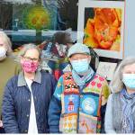At the display window in Uptown Port Townsend are, from left, Jeri Auty, Cheri Kopp, Debra Olson and Sue Gale, contributors to the "Art in a Pandemic" show, on view around the clock at the corner of Tyler and Lawrence streets. (Diane Urbani de la Paz/Peninsula Daily News)