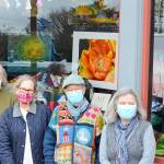 At the display window in Uptown Port Townsend are, from left, Jeri Auty, Cheri Kopp, Debra Olson and Sue Gale, contributors to the Art in a Pandemic show, on view around the clock at the corner of Tyler and Lawrence streets. (Diane Urbani de la Paz/Peninsula Daily News)