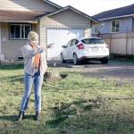 Sidney Murphy stands in front of her home on West 13th Street in Port Angeles by the storm drain on the edge of the dirt road. (Dave Logan/For Peninsula Daily News)