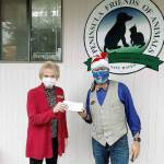 Peninsula Friends of Animals donation Peninsula Friends of Animals Executive Director Danette Grady, left, receives a donation of $150 for the cage-free, no-kill animal welfare group from Tyrone Beatty, the assistant manager of the Port Angeles branch of First Security Bank. (Courtesy photo)