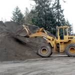 A front-end loader dumps sand into a pile on Wednesday at the Clallam County road maintenance yard in Port Angeles. The potential for lowland snow across the North Olympic Peninsula has prompted many agencies to prepare for winter driving conditions. (Keith Thorpe/Peninsula Daily News)