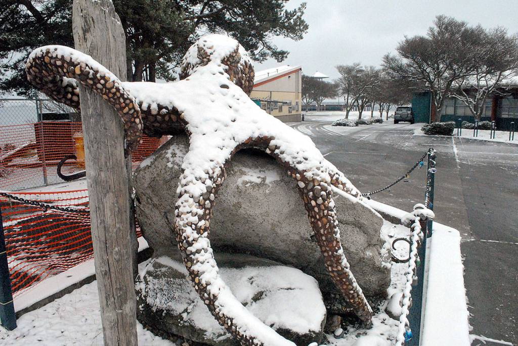 Snow covers the octopus sculpture at Port Angeles City Pier on Thursday. Many areas of the North Olympic Peninsula were delivered with a taste of winter weather on Wednesday night into Thursday with additional snowfall expected across the region this weekend. (Keith Thorpe/Peninsula Daily News)