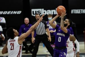 Washington guard Marcus Tsohonis (0) shoots over Washington State center Dishon Jackson (21) during the second half of an NCAA college basketball game in Pullman, Wash., Monday, Feb. 15, 2021.  (AP Photo/Young Kwak)