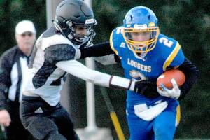 Keith Thorpe/Peninsula Daily News
Crescent's Brenten Dalton, right, tries to evade Lummi Nation's Jaie Leighton during Satuday's matchup in Joyce.