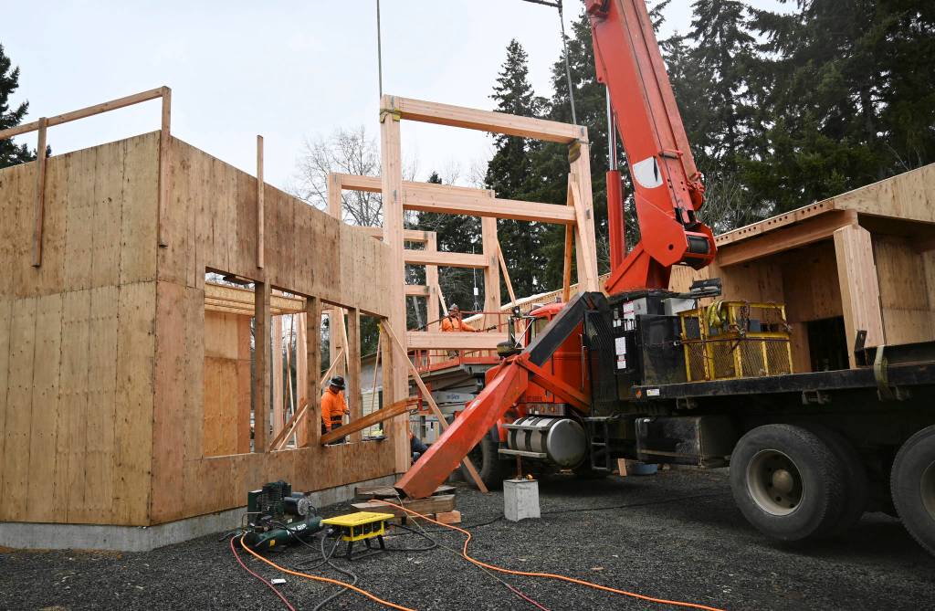 <strong>Michael Dashiell</strong>/Olympic Peninsula News Group
Crew workers with T&D Contracting set in place massive trusses as part of the expansion of the Dungeness River Audubon Center. Construction site superintendent Pete Nesse said the project is still on target for a fall opening date. Just a matter of putting the pieces of the puzzle together, he said.