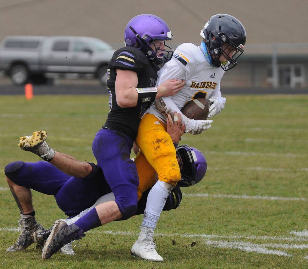 Sequims Isaiah Cowan tackles a Bainbridge wide receiver during the Wolves 38-0 win over the Spartans on Saturday. Cowan returned an interception 40 yards for a score and rushed for another TD in the victory.
Michael Dashiell/Olympic Peninsula News Group