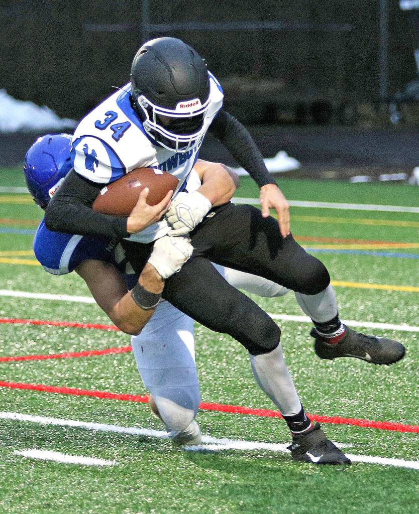 East Jeffersons Logan Massie is tackled by a North Mason defender in Saturdays game in Belfair. (Lisa Jensen photo)