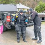 Matt Peaverly of Portland, Ore., helps his wife Grace with her dive gear before they go diving at the Marine Science Center at Fort Worden State Park on Monday. The couple, along with another diver, went diving at various sites during the weekend. (Steve Mullensky/for Peninsula Daily News)