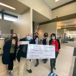 Port Angeles Symphony conductor and music director Jonathan Pasternack, foreground, accepted a major donation for the Adventures in Music program from 1st Security Bank earlier this month. With him at the Sequim branch are, from left, bank staff member Danielle Lorentzen, assistant manager Tyrone Beatty, branch manager Elisa Simonsen and personal banker Rui Starrett. (photo courtesy Port Angeles Symphony)