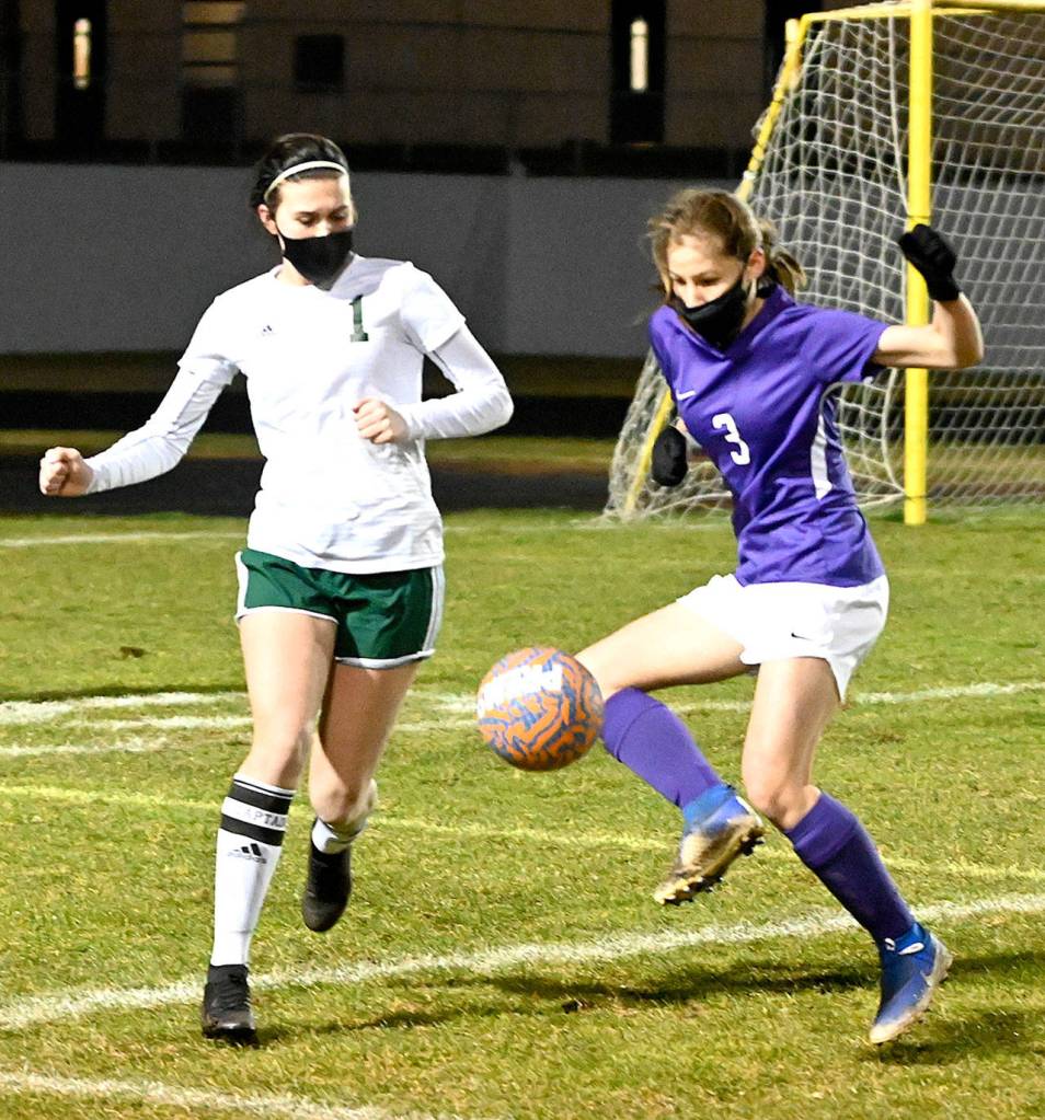 Michael Dashiell/Olympic Peninsula News Group Port Angeles Bailee Larson, left, and Sequims Taryn Johnson vie for a loose ball during the second half of the Roughriders 2-1 win over the Wolves on Friday.