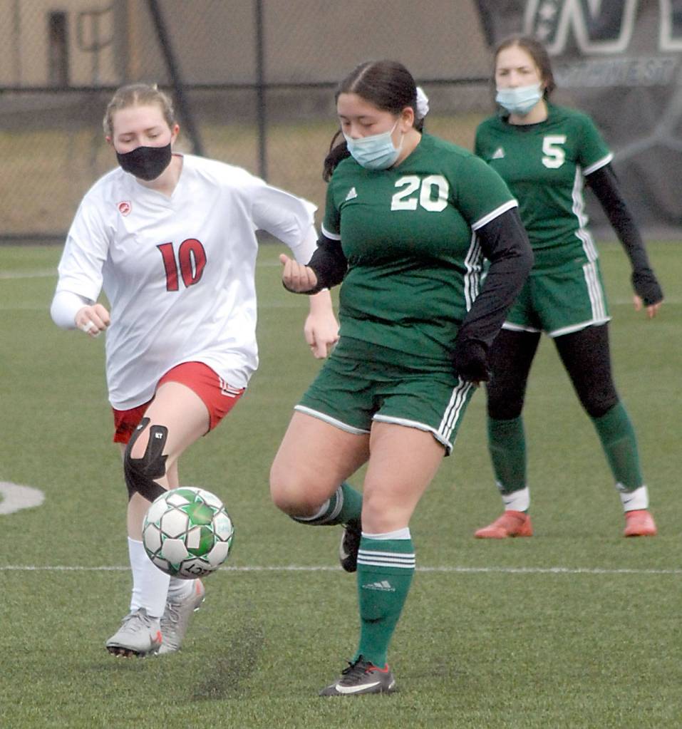 Keith Thorpe/Peninsula Daily News East Jeffersons Clair Johnson, left, races Port Angeles Brielle Keyward for the ball as Mia Gagnon of Port Angeles looks on at right on Saturday at Peninsula College in Port Angeles.