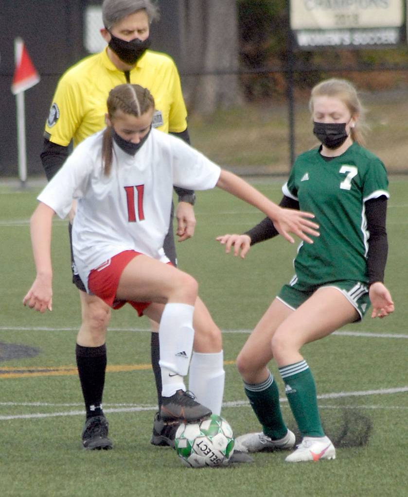 Keith Thorpe/Peninsula Daily News East Jeffersons Iris Mattern dribbles past Port Angeles Izzy Felton in the first half of Saturdays match in Port Angeles.