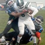 Port Angeles running back Jaziel Livingston is wrapped up by East Jeffersons Nathan Nisbet, left, and Gerald Lindsey in th first quarter on Saturday in Port Angeles. (Keith Thorpe/Peninsula Daily News)