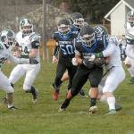 East Jefferson ball carrier Anson Jones, center, is wrapped up Port Angeles Jacob Felton as he breaks through the line. (Keith Thorpe/Peninsula Daily News)
