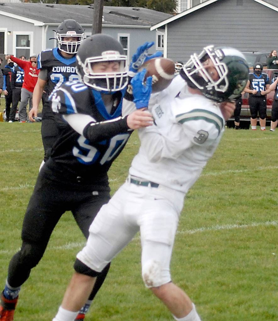 Port Angeles Derek Sparks catches a pass over the defense of East Jeffersons Toby Fulton on Saturday in Port Angeles. (Keith Thorpe/Peninsula Daily News)