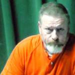 Keith Thorpe/Peninsula Daily News
Dennis Bauer makes is first video appearance in Clallam County Superior Court in Port Angeles on Friday after he was arrested Thursday in connection with a triple homicide in December. Inset in the two-way video appearance is Superior Court Judge Brian Coughenour.