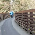 Joan and Bill Henry of Sequim stroll along the Johnson Creek Trestle, part of the Olympic Discovery Trail spanning Johnson Creek east of Sequim. The 410-foot-long trestle was refurbished in 2003 from a former railroad span and opened to pedestrian traffic. (Keith Thorpe/Peninsula Daily News)