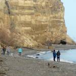 Beach walkers stroll beneath the bluffs on the shore of Sequim Bay near Marlyn Nelson County Park at Port Williams east of Sequim on Saturday. The area is popular with beachcombers and offers views of Protection Island and the Miller Peninsula. (Keith Thorpe/Peninsula Daily News)