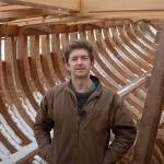 Leo Goolden stands in the wooden hull of Tally Ho, a 1910 cutter he is restoring in the Sequim area. Goolden posted a YouTube video Sunday discussing issues hes had with a neighbor and Clallam Countys Department of Community Development. (Sampson Boat Co. via YouTube)