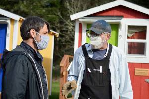 Boeing Bluebills volunteer Dan Nieuwsma, right, talks with Bayside Housing Services case manager Mike Schleckser about building ramps to the shower units at Peter's Place. Diane Urbani de la Paz/Peninsula Daily News