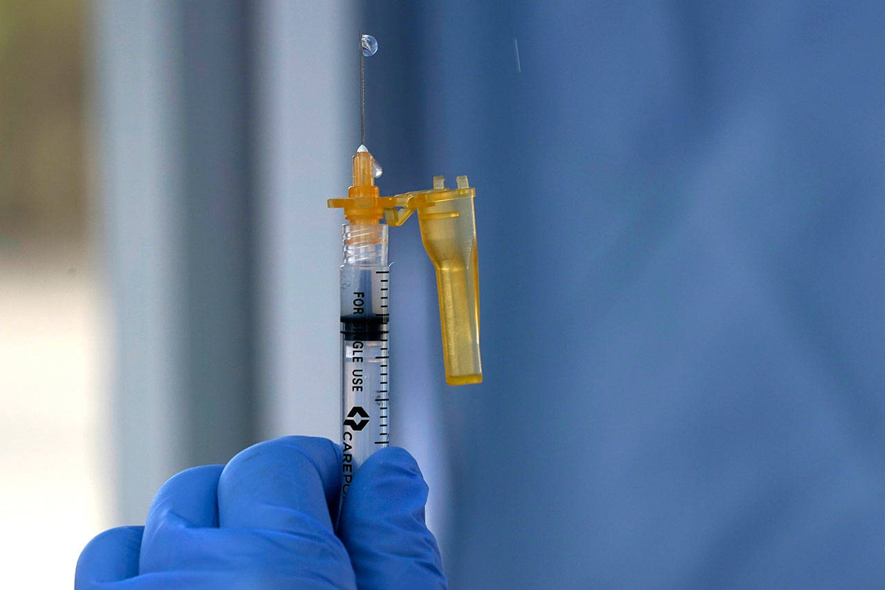 A syringe of the Moderna COVID-19 vaccine is shown Thursday at a drive-up mass vaccination site in Puyallup, south of Seattle. Officials said they expected to deliver about 2,500 second doses of the Moderna COVID-19 vaccine at the site Thursday. (Ted S. Warren/The Associated Press)