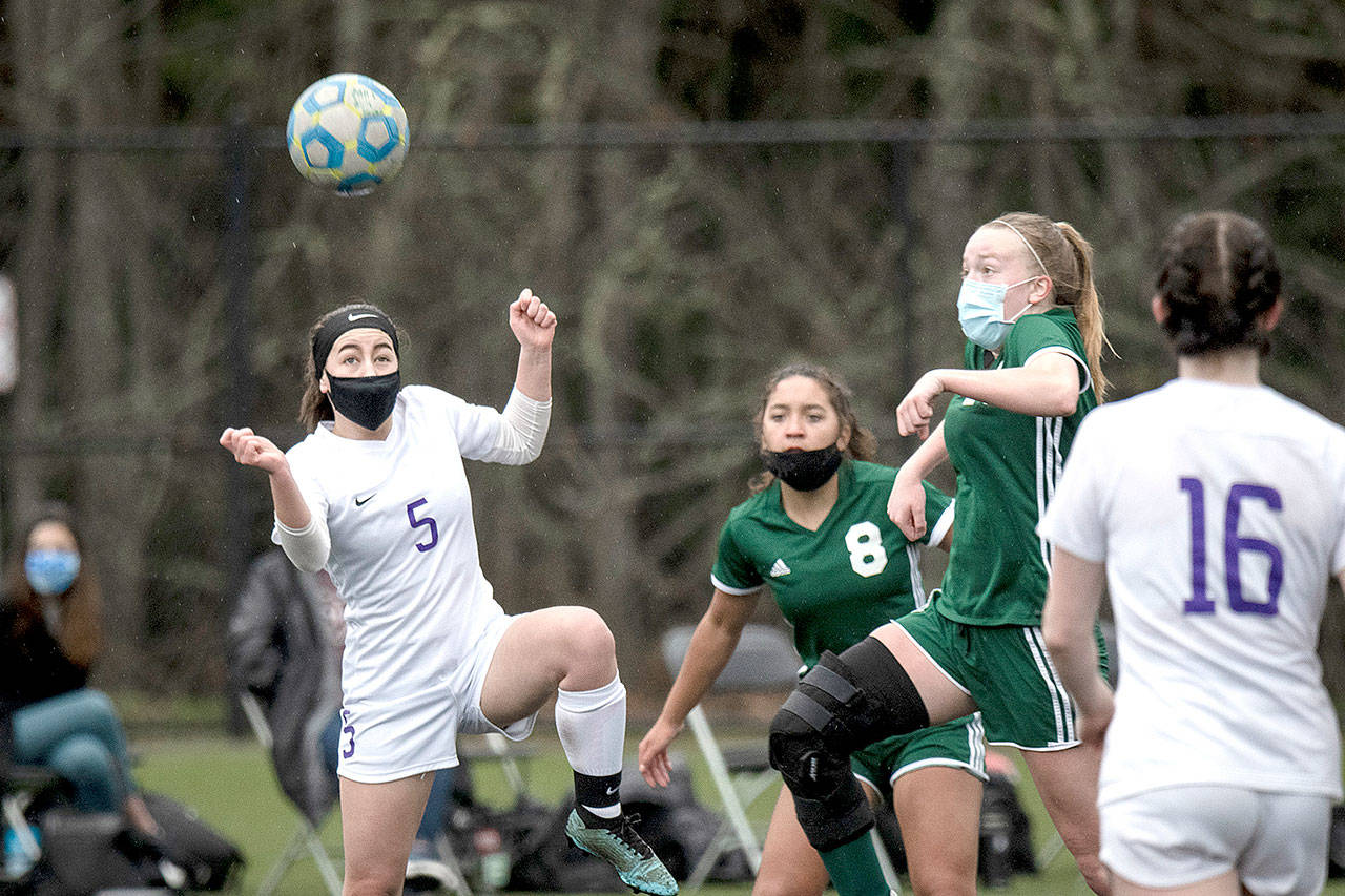 Sequims Kariya Johnson (5) and Port Angeles Anna Petty battle over a loose ball Saturday at Wally Sigmar Field at Peninsula College. (Jesse Major/for Peninsula Daily News)