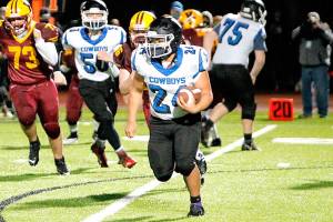 East Jefferson's Anson Jones (24) looks for running room against the Kingston defense Friday night. Jones rushed for 92 yards as Kingston won 12-7.  (Mark Krulish/Kitsap News Group)