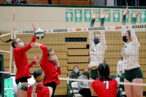 East Jefferson's Macy Aumock, left, and Sophie Patterson fend off a block by Port Angeles' Zoe Smithson and Ava Brenkman, right, as East Jefferson's Akira Anderson, front left, and Jessica Hawley, front right, look on during the first game of Tuesday's match at Port Angeles High School. (Keith Thorpe/Peninsula Daily News)