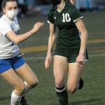 <strong>Keith Thorpe</strong>/Peninsula Daily News
Port Angeles Millie Long, right, looks past the defense of Olympics Claire Caldwell in the first half of Thursday nights match at Peninsula College in Port Angeles.