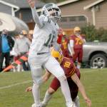 Port Angeles quarterback Parker Nickerson gets off a pass as Kingstons Kyler Coe-Yarr closes in on Saturday in Port Angeles. (Keith Thorpe/Peninsula Daily News)