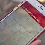 FILE - In this Jan. 3, 2019, file photo, a mobile phone customer looks at an earthquake warning application on an iPhone in Los Angeles. An earthquake early warning system operated by the U.S. Geological Survey has been activated in Oregon on the 10th anniversary of the devastating earthquake and tsunami in Japan. California already has the system. Washington state joins it in May, which will complete coverage of the West Coast of the contiguous United States. (AP Photo/Richard Vogel, File)