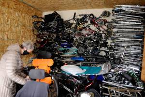 Rosalie DiMaggio inspects a wheelchair as part of her churchs effort to bring in enough wheelchairs, canes, walkers and more to fill a 40-foot storage container and send to Guatemala. (Matthew Nash /Olympic Peninsula News Group)