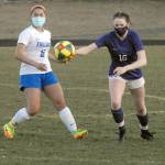Olympics Alexis Valenzuela, left, and Sequims Abigail Schroeder chase after a loose ball during Tuesday nights match at Sequim High School. (Keith Thorpe/Peninsula Daily News)