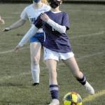 Sequims Alliyah Weber, front, struggles to keep the ball in bounds while pursued by Olympics Kailyn Wolfe on Tuesday night in Sequim. (Keith Thorpe/Peninsula Daily News)